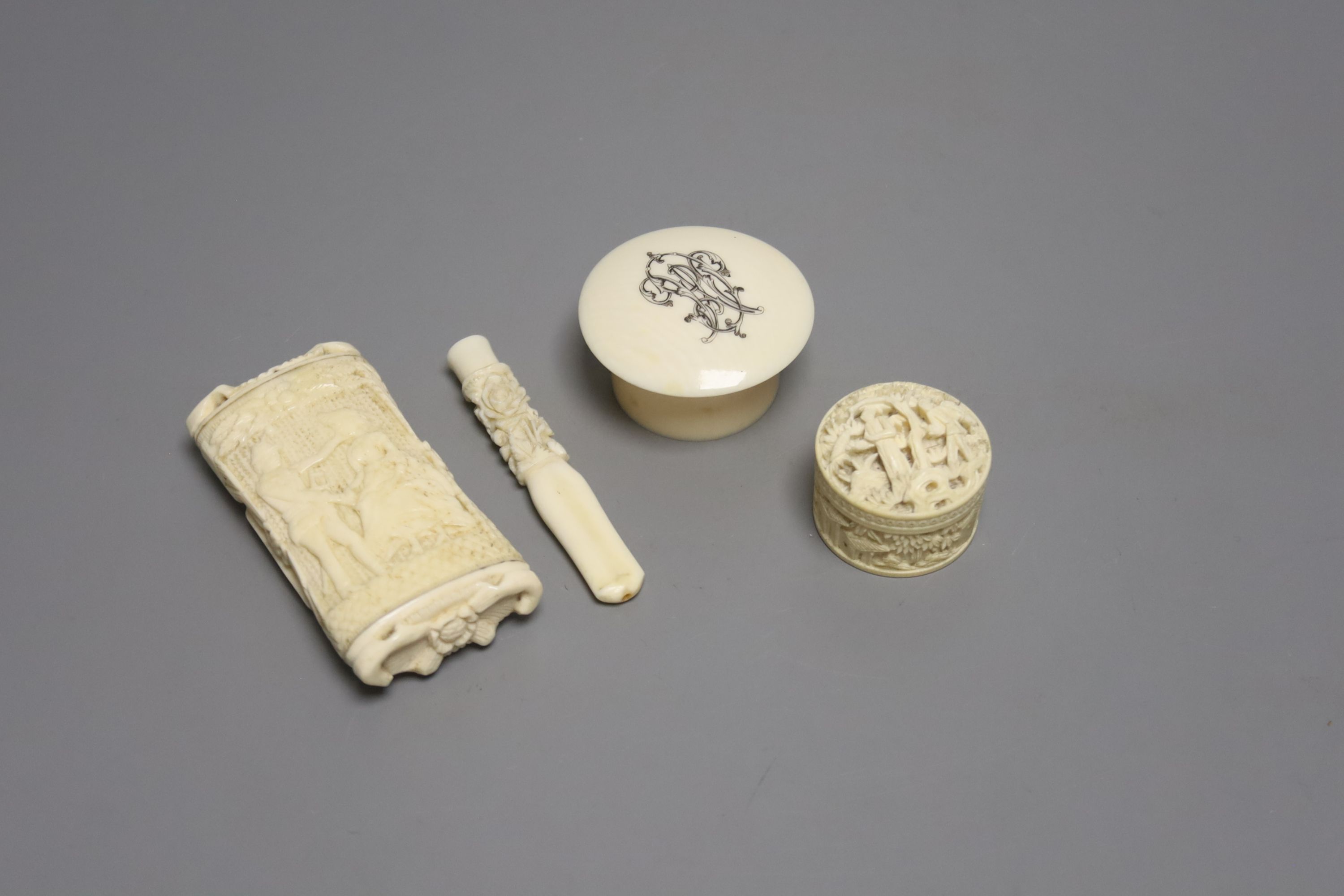 A small group of decorative ivory/bone including two trinket boxes, a snuff box and a cheroot holder